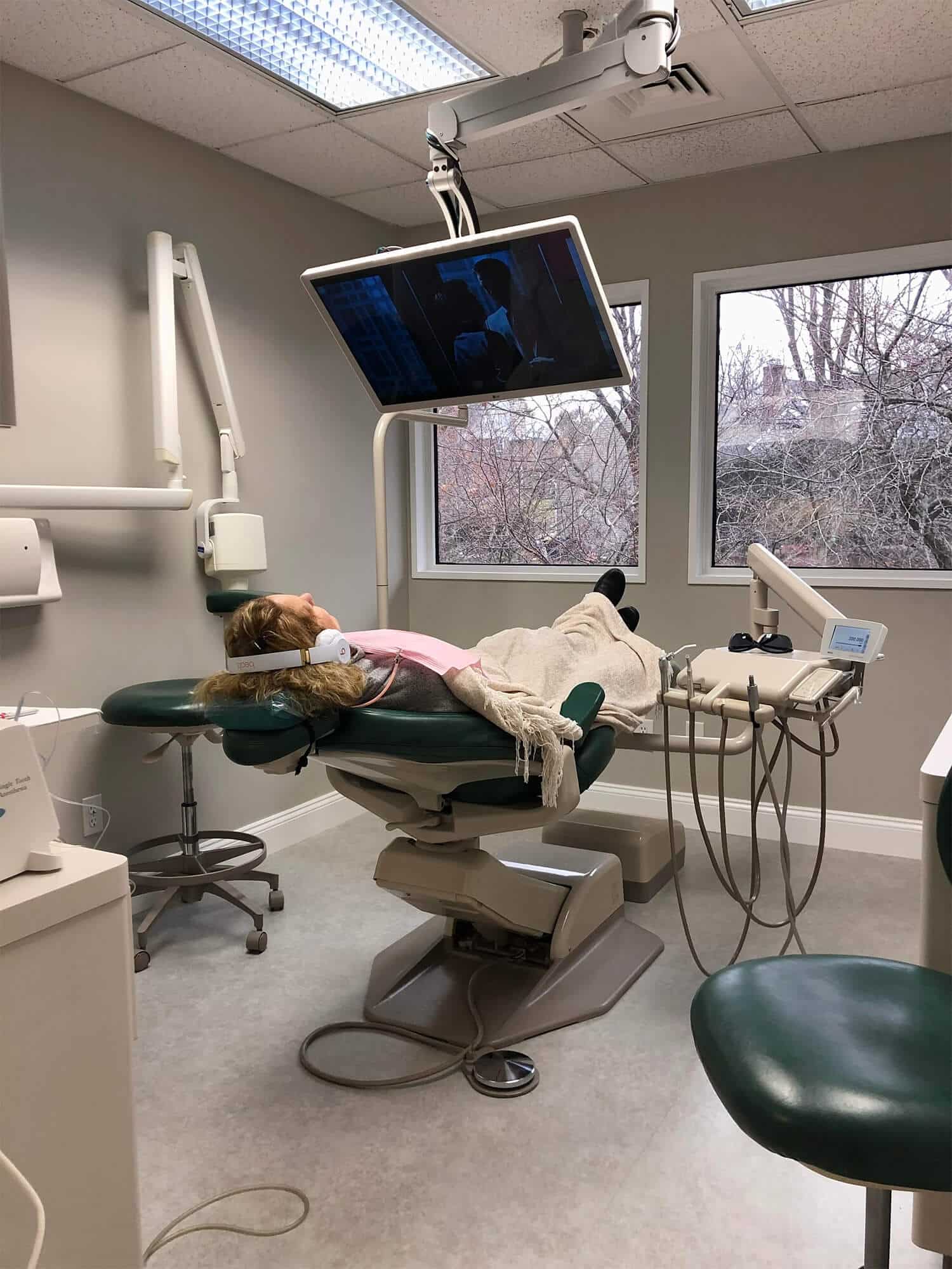 inside close up of dental operating room with large window and tv
